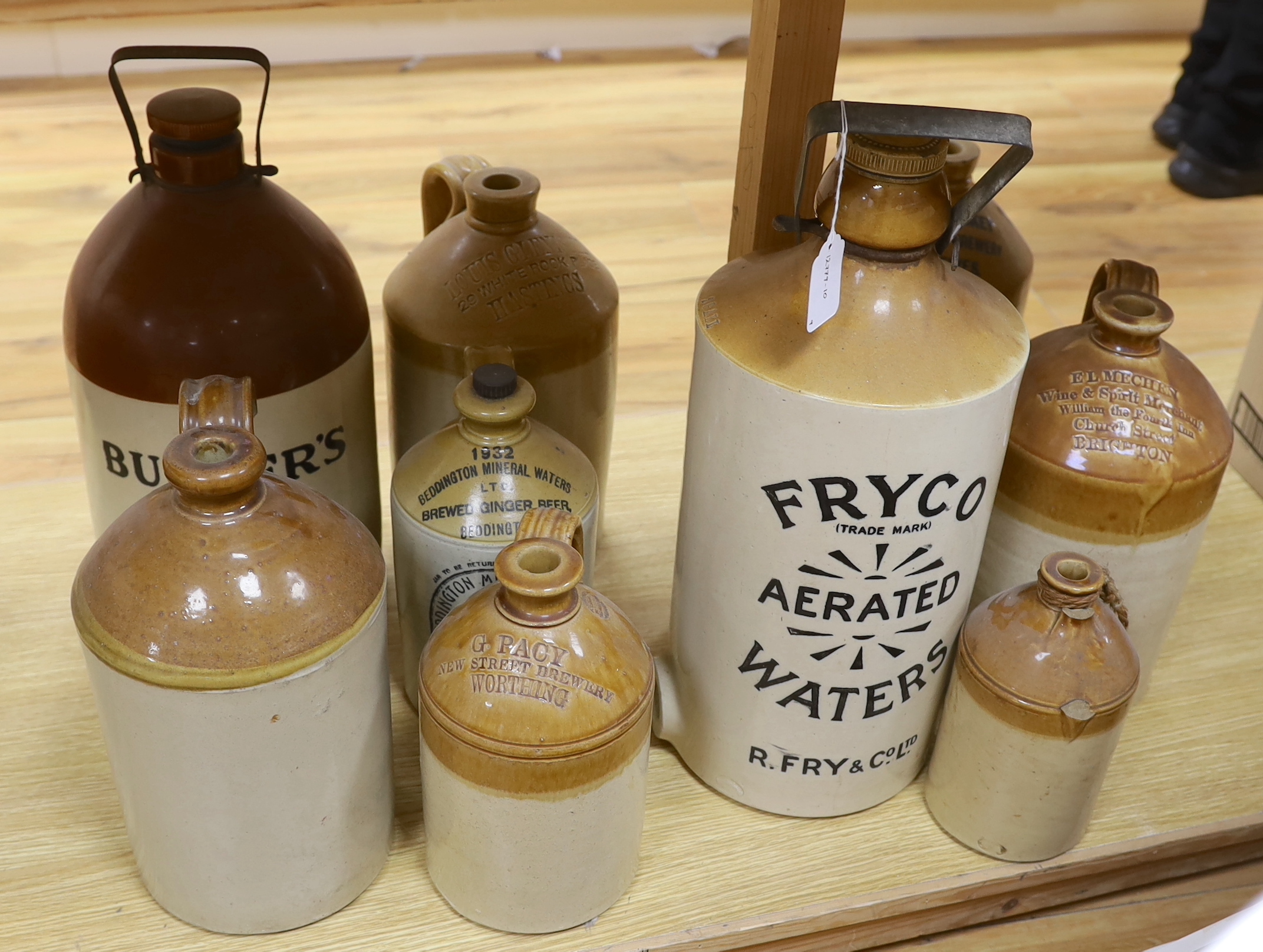9 various stoneware vessels including local brewers such as Lewes, Worthing, Hastings and Brighton